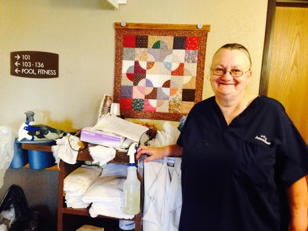 Mary pauses for a quick photo before completing her shift at the AmericInn in Roseau, Minn. 